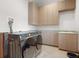 Modern laundry room with stainless steel appliances and ample cabinet space at 1930 Bayshore Dr, Englewood, FL 34223