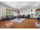 Spacious living room with hardwood floors, leather sofas, and a decorative area rug at 1930 Bayshore Dr, Englewood, FL 34223