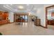 Open living space with a grand piano and a view to a dining area and sliding doors to the outside at 1930 Bayshore Dr, Englewood, FL 34223