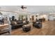 Spacious open-concept living room with leather furniture, tile floors, and access to the pool at 1930 Bayshore Dr, Englewood, FL 34223