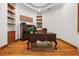 Cozy office with wood floors, built-in shelves, decorative wood trim and an ornate wooden desk at 1930 Bayshore Dr, Englewood, FL 34223