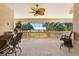 Screened patio with ceiling fan, chairs and lovely view of the outside at 1930 Bayshore Dr, Englewood, FL 34223
