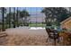 Enclosed pool with brick patio, wrought iron furniture and lush lawn extending to the water at 1930 Bayshore Dr, Englewood, FL 34223