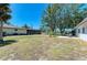 Large backyard with plenty of room for outdoor activities and includes a covered patio area at 2402 Scenic Dr, Venice, FL 34293