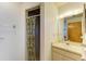 Bright bathroom featuring a single sink vanity, a mirror, and a shower with a curtain at 2402 Scenic Dr, Venice, FL 34293