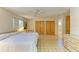 Bedroom featuring tiled floors, ceiling fan, double closets, and a window for natural light at 2402 Scenic Dr, Venice, FL 34293