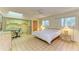 Bedroom area with skylight, tiled floor, built-in desk, and a partial kitchen area at 2402 Scenic Dr, Venice, FL 34293
