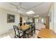 Open-concept dining area with tile flooring, bright light, and views into the living room and front door at 2402 Scenic Dr, Venice, FL 34293