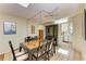 Well-lit dining area boasts an elegant table set and is open to the kitchen with lots of natural light at 2402 Scenic Dr, Venice, FL 34293