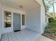 Inviting front entrance with tiled floor, gray door, and sidelight windows at 2402 Scenic Dr, Venice, FL 34293