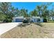 Charming single-story home featuring a well-maintained front yard, mature trees, and a two-car garage at 2402 Scenic Dr, Venice, FL 34293