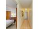 Hallway view leading to a bedroom with visible furnishings and tiled flooring at 2402 Scenic Dr, Venice, FL 34293
