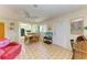 Inviting living space with tile floors, ceiling fan, TV, work desk, and easy access to the kitchen area at 2402 Scenic Dr, Venice, FL 34293