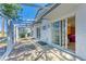 A covered patio with a view to the house showcasing sliding glass doors to the interior at 2402 Scenic Dr, Venice, FL 34293