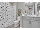 Neat bathroom with a shower-tub combo, a modern vanity, and a decorative shower curtain at 253 Tracino Ter, Nokomis, FL 34275
