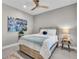 Inviting bedroom with a ceiling fan, a comfy bed, and colorful wall art for a relaxing atmosphere at 253 Tracino Ter, Nokomis, FL 34275