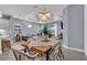 Inviting dining area featuring stylish lighting and views of the backyard and open-concept living space at 253 Tracino Ter, Nokomis, FL 34275
