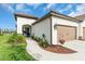 Charming home featuring a tile roof, stucco exterior, beautiful landscaping, and a two-car garage at 253 Tracino Ter, Nokomis, FL 34275