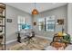 Bright home office featuring a sleek desk, a comfortable chair, and natural light from two windows at 253 Tracino Ter, Nokomis, FL 34275