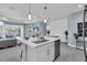 Modern kitchen with a center island, stainless steel appliances, and ample cabinet space at 253 Tracino Ter, Nokomis, FL 34275