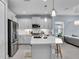 Well-equipped kitchen featuring white cabinets, stainless appliances, and a breakfast bar at 253 Tracino Ter, Nokomis, FL 34275