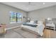 Serene main bedroom with a neutral color scheme, plush bedding, and a scenic window view at 253 Tracino Ter, Nokomis, FL 34275