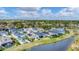 Aerial view of a neighborhood with houses and a lake at 2538 Fireflag Ln, Sarasota, FL 34232