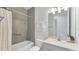 Bathroom featuring tiled shower-tub, vanity with sink, and neutral color scheme at 2538 Fireflag Ln, Sarasota, FL 34232