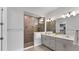 Modern bathroom featuring double vanity, tiled walk-in shower, and neutral color palette at 2538 Fireflag Ln, Sarasota, FL 34232