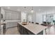 Modern kitchen with stainless steel appliances and large island with seating at 2538 Fireflag Ln, Sarasota, FL 34232