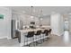 Open kitchen with stainless steel appliances, granite countertops, and center island with bar seating at 2538 Fireflag Ln, Sarasota, FL 34232