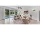 Bright living room with a comfortable seating arrangement and sliding glass doors at 2538 Fireflag Ln, Sarasota, FL 34232