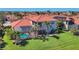 This home features a screened-in pool and lush landscaping and a red tile roof at 261 Portofino Dr, North Venice, FL 34275