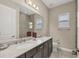 Bathroom with double vanity, granite countertops, and modern fixtures creating a luxurious and functional space at 261 Portofino Dr, North Venice, FL 34275