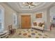 Bright, airy room features a tray ceiling, ample natural light from two windows, and hardwood floors at 261 Portofino Dr, North Venice, FL 34275