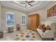 Bright, airy room features a tray ceiling, ample natural light from two windows, and hardwood floors at 261 Portofino Dr, North Venice, FL 34275