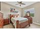 Comfortable bedroom with ceiling fan, tile floors, and a view to the outside at 261 Portofino Dr, North Venice, FL 34275