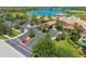 Aerial view capturing the beautiful clubhouse, surrounded by pristine landscaping and a manicured parking area at 261 Portofino Dr, North Venice, FL 34275