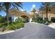View of the inviting clubhouse entrance, showcasing well-maintained landscaping and covered entry at 261 Portofino Dr, North Venice, FL 34275