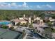 Aerial view of the community clubhouse and amenities including pool and tennis courts at 261 Portofino Dr, North Venice, FL 34275