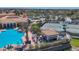 Aerial view of the resort-style community pool, with seating areas and tennis courts at 261 Portofino Dr, North Venice, FL 34275