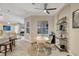Cozy dining area adjacent to the kitchen, featuring a ceiling fan and an abundance of natural light at 261 Portofino Dr, North Venice, FL 34275