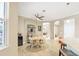 Well lit dining area adjacent to the kitchen with tile floors and a view to the main living space at 261 Portofino Dr, North Venice, FL 34275