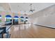 Spacious fitness room with hardwood floors, large mirrors, ceiling fans, and exercise equipment at 261 Portofino Dr, North Venice, FL 34275