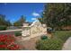The Golf Club sign surrounded by beautiful flowerbeds and greenery in a well maintained landscape at 261 Portofino Dr, North Venice, FL 34275