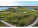 Scenic aerial of the golf course, featuring well-maintained greens, sand bunkers, and tranquil water features at 261 Portofino Dr, North Venice, FL 34275