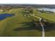 Picturesque aerial view of the meticulously maintained golf course, with ponds, sand traps and a smooth cart path at 261 Portofino Dr, North Venice, FL 34275