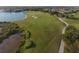 Scenic aerial shot of golf course highlighting lush greenery, water features, bunkers and smooth cart paths at 261 Portofino Dr, North Venice, FL 34275