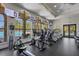Well-equipped gym overlooking the pool with treadmills and other fitness machines at 261 Portofino Dr, North Venice, FL 34275