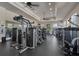 Well-equipped fitness center with various weight machines, mirrors, ceiling fans and mounted televisions at 261 Portofino Dr, North Venice, FL 34275
